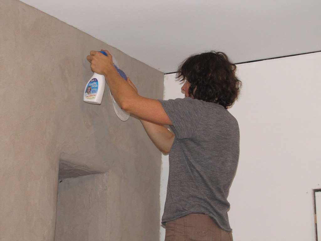 plasterer smoothing fresh wall coating